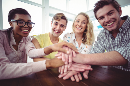 Creative businessteam making a large motivation gesture in casual officeの写真素材