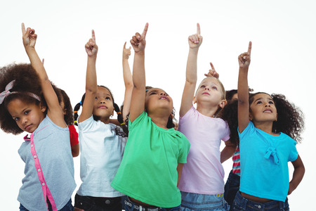 Line of girls standing with hands pointing up against a white backgroundの写真素材