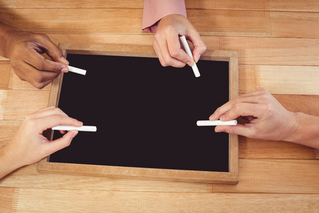 Young creative team using chalkboard in casual officeの写真素材