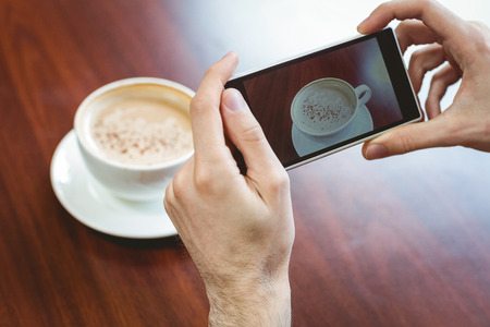 Hipster student using laptop in canteen at the universityの写真素材