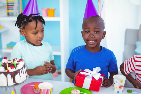 Excited kid enjoying a birthday party looking at the cameraの写真素材