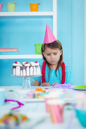 Sad kid alone at her birthday partyの写真素材