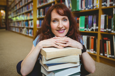 Mature student smiling in library  at the universityの写真素材