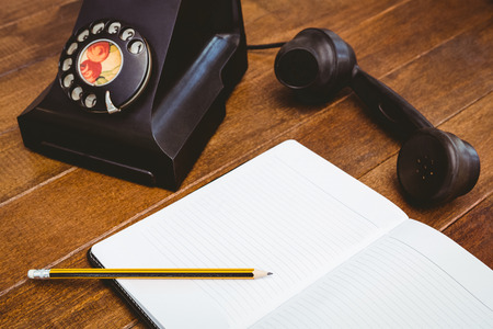 View of an old phone on wood deskの写真素材