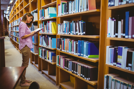 Mature student in the library at the universityの写真素材