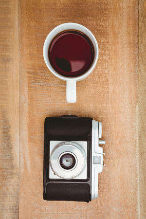 View of an old camera and a coffee on wood deskの写真素材