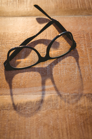 Close up view of hipster glasses on wood deskの写真素材