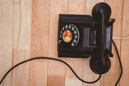View of an old phone on wood deskの写真素材