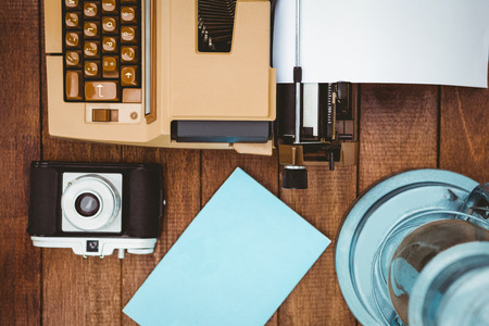 View of an old typewriter and camera on wood deskの写真素材