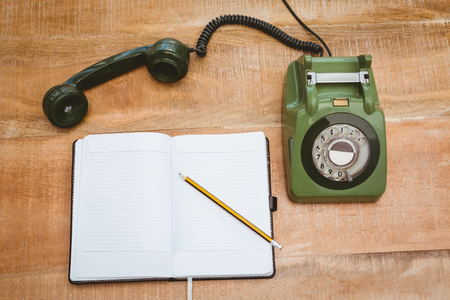 View of an old phone on wood deskの写真素材