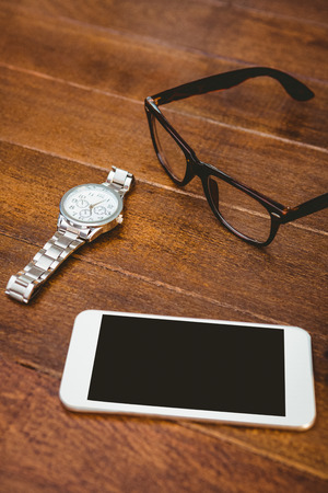 Close up view of smartphone and glasses on wood plankの写真素材