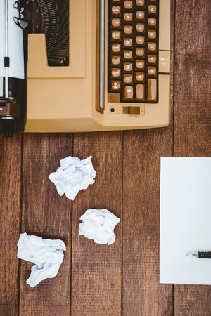 View of an old typewriter and paper on wood deskの写真素材