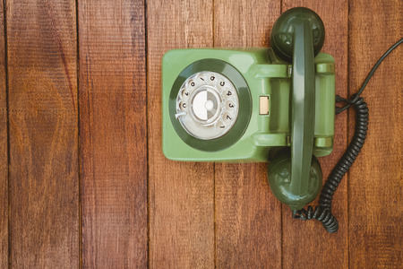 View of an old phone on wood deskの写真素材