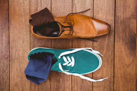 View of two different shoes on wood plankの写真素材