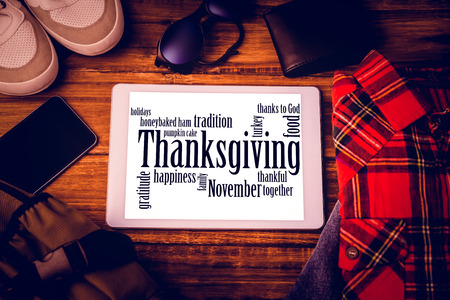 Thanksgiving words against shirt shoes jean glasses next to wallet smartphone and bagの写真素材