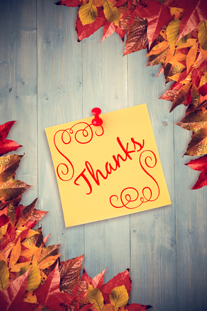thank you against autumn leaves with yellow noteの写真素材