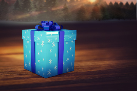 Christmas gifts against fir tree forest in snowy landscape