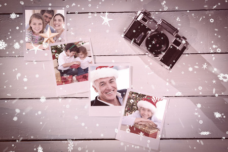 Family Christmas portrait against instant photos on wooden floorの写真素材