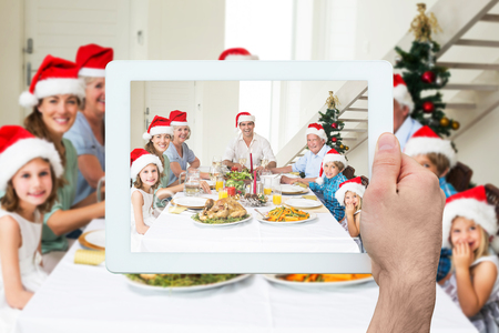 Composite image of hand holding tablet pcの写真素材
