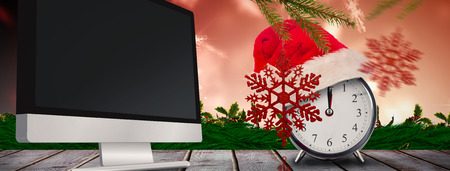 Christmas clock against digitally generated grey wooden planksの写真素材