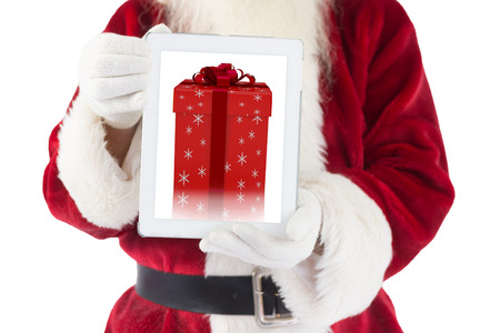 Santa claus showing tablet pc against red and silver gift boxの写真素材