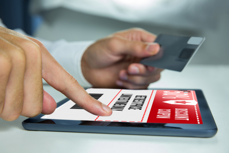 Man using tablet against sale advertisementの写真素材