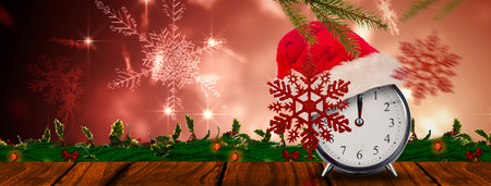 Christmas clock against snowflake design shimmering on red