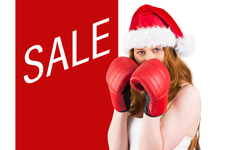 Festive redhead with boxing gloves against sale advertisementの写真素材