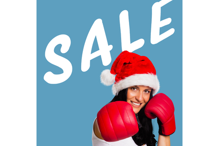 Woman wearing red boxing gloves against sale advertisementの写真素材