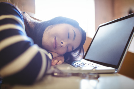 Sleeping student in lecture hall at the universityの写真素材