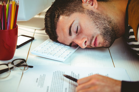 Man asleep at his desk in his officeの写真素材