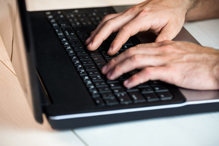 Man using his laptop at a desk