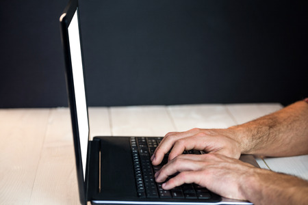 Man using his laptop at a deskの写真素材