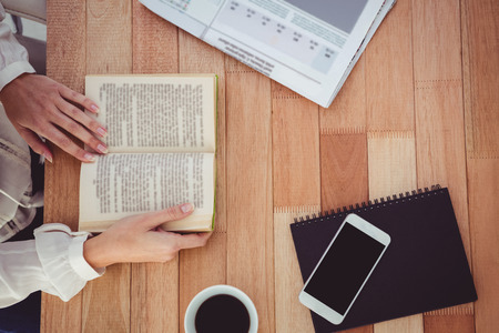 Cropped hand of woman holding bookの写真素材