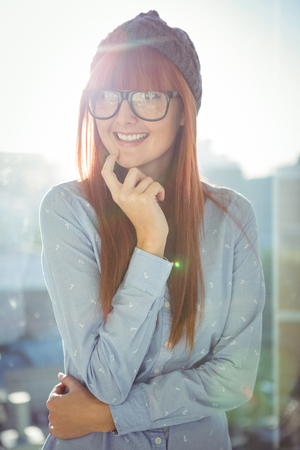 Portrait of smiling hipster woman posing in a bright roomの写真素材