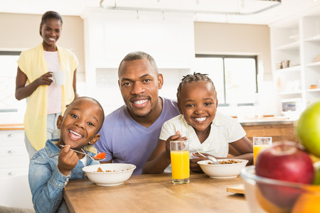 Casual happy family having breakfast in the kitchenの写真素材