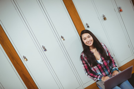 Smiling student sitting at the computer at the university