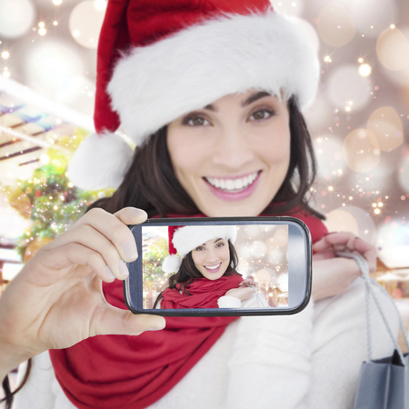 Composite image of hand holding smartphone showingの写真素材