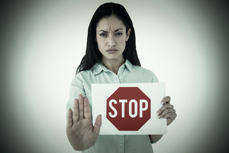 Woman showing card and saying stop against stop signの写真素材