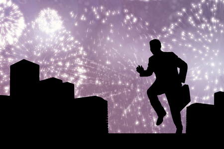 Businessman with briefcase against white fireworks exploding on black backgroundの写真素材
