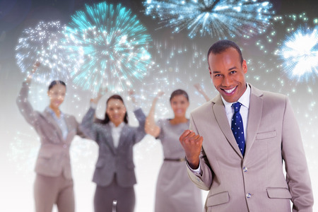 Successful business team with a man in the foreground against colourful ...