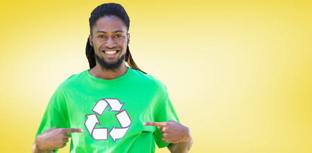 Happy environmental activist in the park against yellow vignetteの写真素材