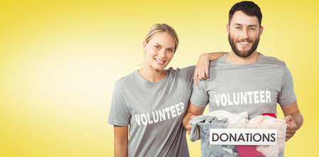 Portrait of happy man and woman  against yellow vignetteの写真素材