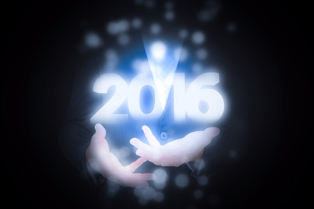 Businessman gesturing with his hands against 2016 graphic