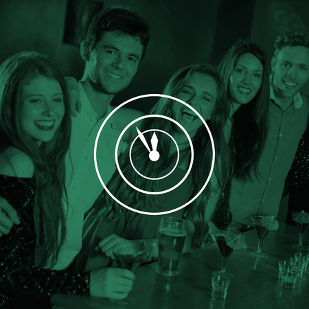 Clock against happy friends on a night out togetherの写真素材