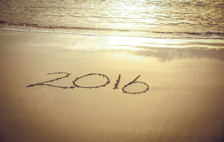 2016 on sand at beach near the waterの写真素材