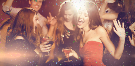 Flying colours against happy friends having fun togetherの写真素材