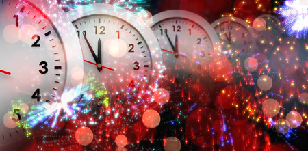 Clocks against colourful fireworks exploding on black backgroundの写真素材