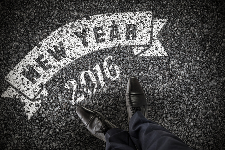 Businessman standing isolated on white background against black roadの写真素材