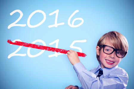 Cute pupil writing against blue background with vignetteの写真素材